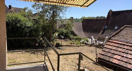 Au pied de la superbe église de Plazac, maison en pierre avec jardin de curé. Très belle affaire.