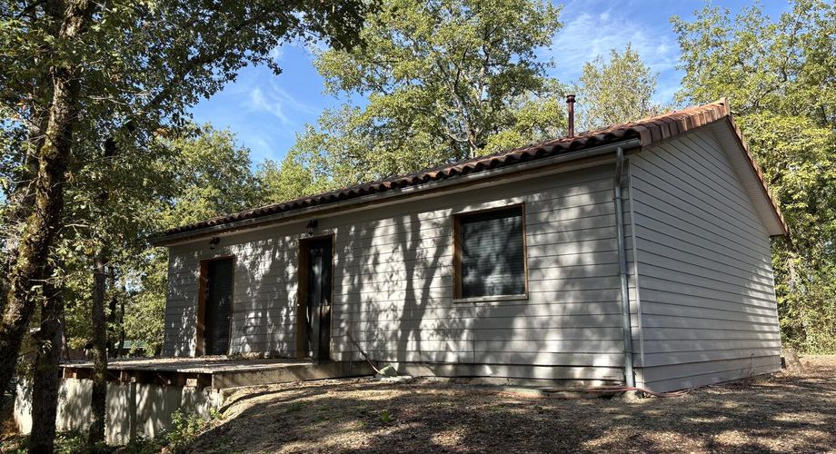 En Périgord Noir, sur les hauteurs de Montignac, petite maison ossature bois dans un environnement boisé.
